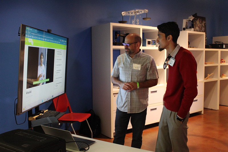 Two students viewing a TV display presentation.