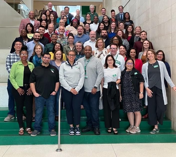 LT group of faculty, students, and staff standing on a stairway.